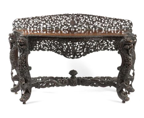 λ λ A BURMESE ROSEWOOD CONSOLE TABLESECOND HALF 19TH CENTURYall over carved with scrolling leaves, flowers, pineapples and fr