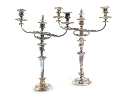 A PAIR OF SILVER PLATED THREE LIGHT CANDELABRAIN GEORGE III STYLE, LATE 19TH / EARLY 20TH CENTURYeach with twin reeded and le