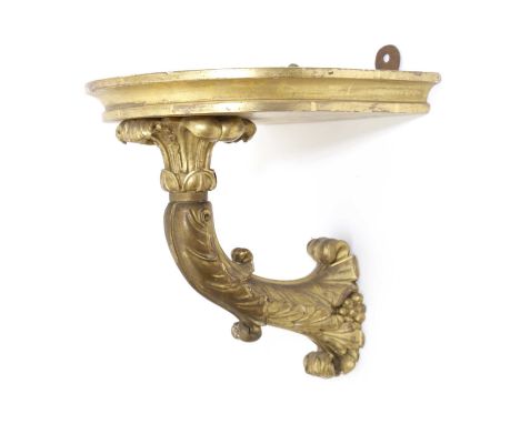 A REGENCY CARVED GILTWOOD BRACKETEARLY 19TH CENTURYthe bowfront shelf supported on a foliate bracket24cm high, 22.9cm wide, 2