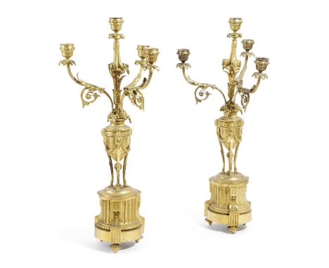 A PAIR OF FRENCH ORMOLU FOUR LIGHT CANDELABRAIN LOUIS XVI STYLE, MID-19TH CENTURYeach with an amphora on three monopodia supp