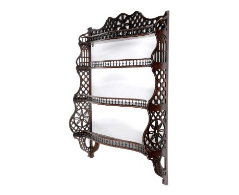 A SET OF MAHOGANY SERPENTINE WALL SHELVESIN CHINESE CHIPPENDALE STYLE, 19TH CENTURYwith four graduated tiers and turned spind