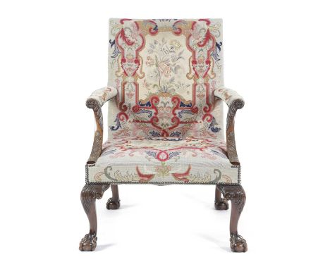 A WALNUT GAINSBOROUGH ARMCHAIR IN GEORGE II STYLE, FIRST HALF 20TH CENTURYthe padded back, seat and armrests covered with flo