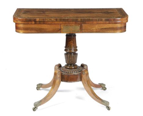 λ λ A REGENCY ROSEWOOD AND BRASS INLAID CARD TABLEEARLY 19TH CENTURYthe swivel fold-over top inlaid with marquetry, revealing
