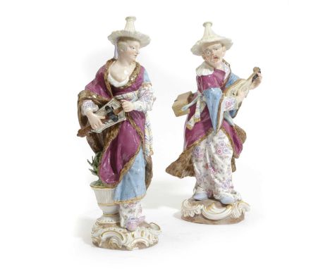A PAIR OF MEISSEN PORCELAIN MALABAR MUSICIAN FIGURESAFTER F.E. MEYER, 19TH CENTURYeach wearing a straw hat and patterned cost