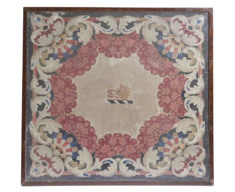 A VICTORIAN TAPESTRY PANELMID-19TH CENTURYworked in gross and petit point with an armorial crest of a boar's head inside a fl