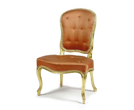 A GEORGE III GILTWOOD SIDE CHAIRIN THE FRENCH MANNER, LATE 18TH CENTURYthe padded back and seat button upholstered with pink 