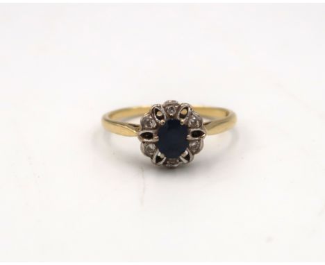 An 18ct yellow gold sapphire and diamond cluster ring, size P/O, approx 2.7 grams