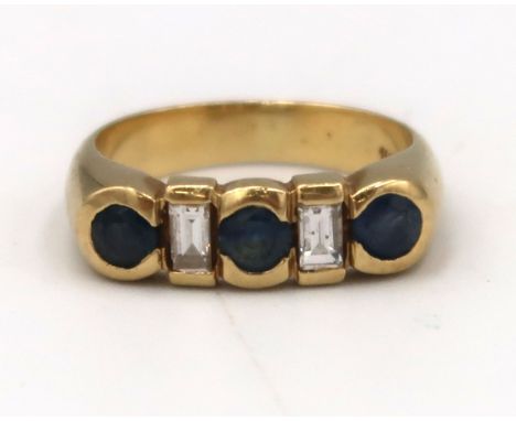 A circular sapphire and baguette diamond dress ring. Size K. Weight 5.25 grams. Stamped 18K.