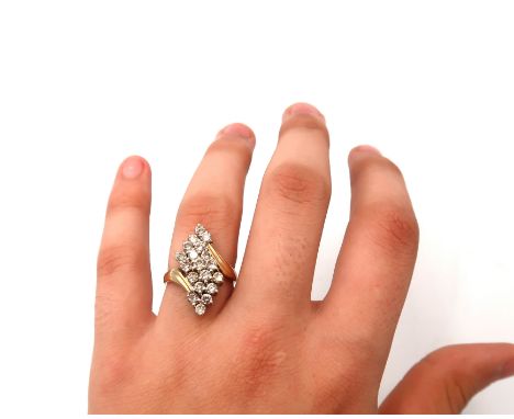 A brilliant cut diamond crossover brilliant cut diamond dress ring cluster. Estimated total weight 1.50ct. Stamped 10K. Size 