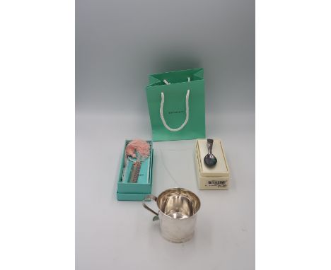 A Tiffany Christening comb, complete with original pink tassle, Tiffany cloth bag, box and paper bag, together with a silver 