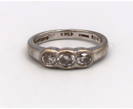 An 18ct white gold hallmarked three stone diamond ring, total ct weight 0.74cts, estimated clarity VVS1, estimated colour G, 