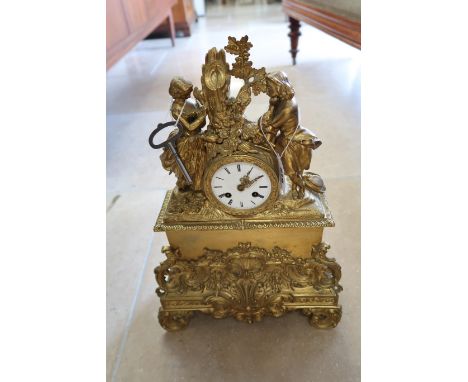 A French gilt bronze mantle clock, modelled with a courting couple above, 45cm high.