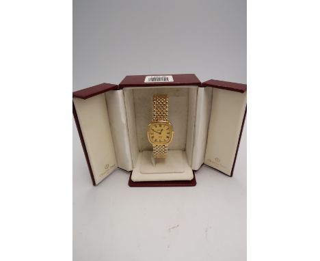 A boxed Christian Dior lady's gold plated wristwatch on bracelet strap, with Roman numerals to the champagne coloured dial.