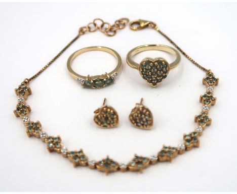 Four pieces of 9ct gold Alexandrite jewellery. To include a panel bracelet. Weight 5.56 grams. A heart shape panel ring. Size