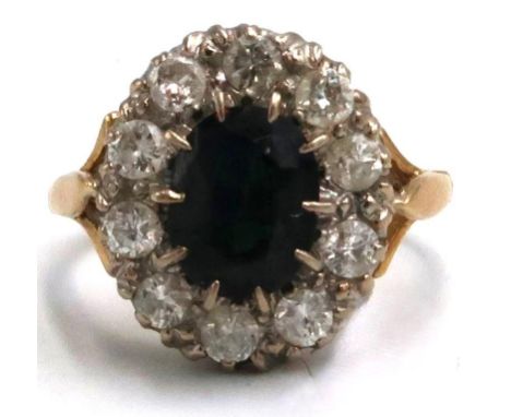 An oval sapphire and diamond cluster ring, estimated total diamond weight 1ct, stamped 18ct 750, size T 1/2 approx 7.44 grams