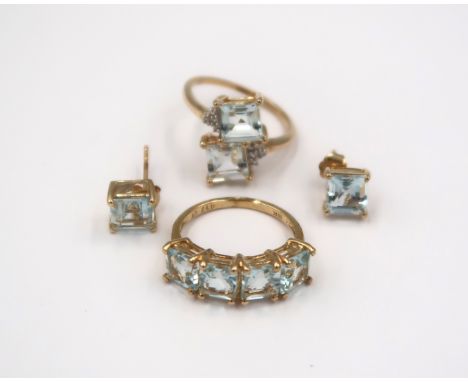 Three pieces of 9ct gold aquamarine jewellery. To include a square shape four stone ring size K. A pair of square shape ear s