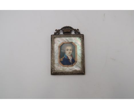 A late 18th century miniature portrait of a gentleman mounted in a gilt frame in a gold coloured canted frame, the back with 