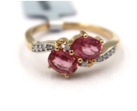 A 9ct gold oval Padparadscha sapphire and single cut diamond crossover ring. Size M. Weight 2.17 grams.