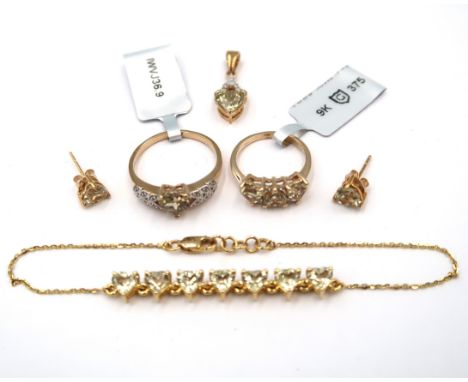 Five pieces of 9ct csarite jewellery. To include a heart shape three stone ring with zircon highlights. Size K. Weight 2.45 g