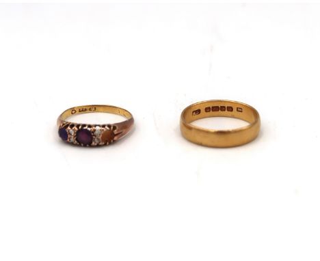 A 22ct H.M. Yellow gold wedding band and a 22ct dress ring, Size M and L respectively. 7.1 Grams.