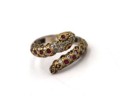 A crossover snake ring set with CZ and ruby, possibly synthetic. Size T. Stamped 925. Weight 3.92 grams