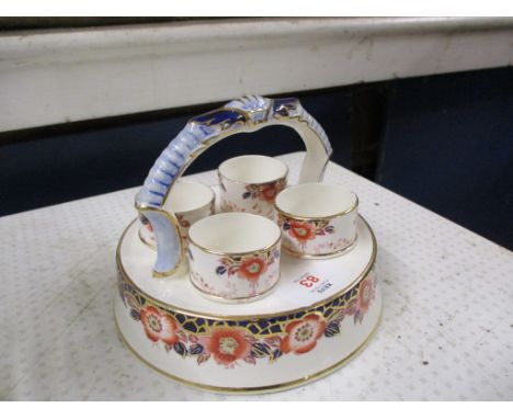 COLLECTION OF FOUR EGG CUPS IN STAND DECORATED IN IMARI STYLE