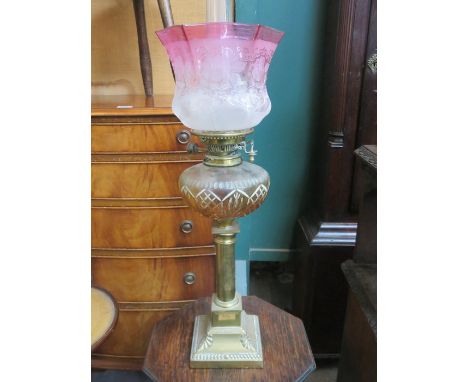 VINTAGE BRASS OIL LAMP WITH AMBER COLOURED GLASS RESERVOIR AND CRANBERRY COLOURED SHADE, BY HINKS DUPLEX, APPROXIMATELY 62cm 