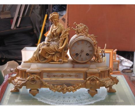 HIGHLY DECORATIVE GILT METAL AND MARBLE EFFECT FRENCH STYLE MANTEL CLOCK DEPICTING A SEATED FIGURE, STAMPED 
