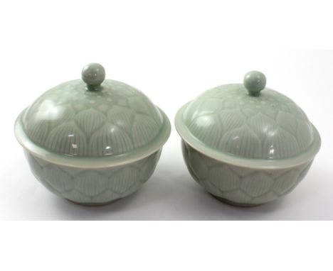 A pair of Chinese celadon bowls and covers, with incise moulded leaf decoration to the body and to the lid, with Chinese seal