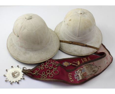 A pair of polo helmets, 'Specially manufactured, first quality waterproof guaranteed cork for A Cader, M Saiboo &amp; Co, Hig