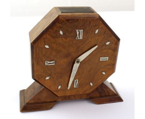 A mid-20th century walnut mantel clock of octagonal form and with Roman dial split with batons, the works marked 'Rotherham's