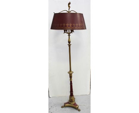 A brass Neo-Classical standard lamp with paw feet and anthemion decoration and painted lower column, surmounted by four eagle
