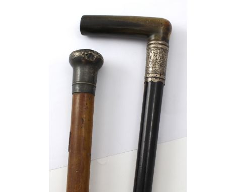 A gentlemen's ebonised walking cane with horn handle, the silver ferrule marked 'Presented to R. Roberts, Treasurer by the me