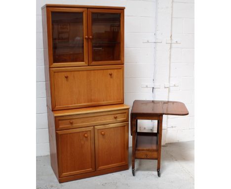 A c1950s drop-leaf trolley with lower shelf and cutlery drawer, to castors, length when extended 92cm and a retro teak displa