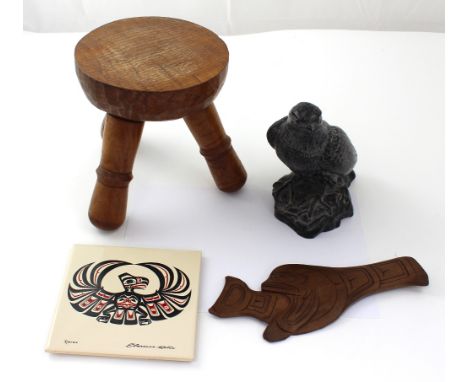 A handmade Aarktik Sculptures hand carved soapstone eagle, a North American eagle decorated tile by Clarence Weller, a carved