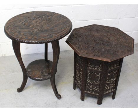 An early 20th century Oriental circular carved table, dragon and floral decoration, lower shelf to three curved supports, dia