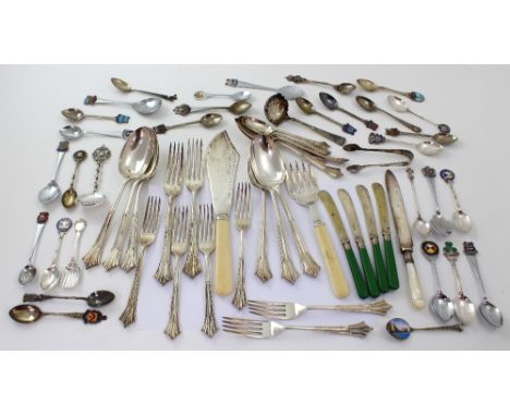 A mixed lot of plated flatware to include knives, forks, and spoons and a collection of enamel finial collectors' teaspoons.