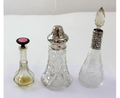 Two cut glass silver mounted bottles and a plated example with guilloché enamel decoration (3).