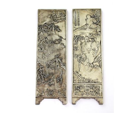 Two Chinese ingots modelled as dressing screen panels; one depicting a scholar on deerback, looked down upon by a boy with pi