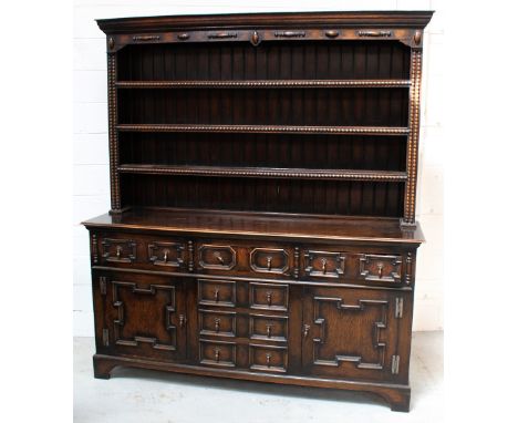 A reproduction oak three-shelf dresser with an arrangement of six drawers and two cupboard doors, 172 x 139cm.