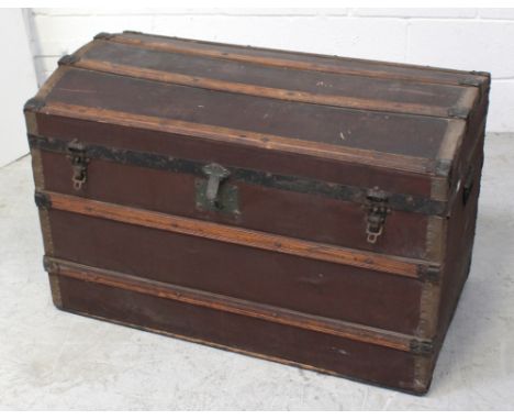 A late 19th/early 20th century travel trunk with wooden slats, iron banding and handles (af) 61 x 92cm.