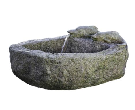 A Continental rough hewn granite basin, 18th/19th century, of segmental section  A Continental rough hewn granite basin,   18