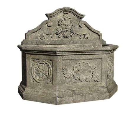 A Continental carved limestone wall fountain in early 17th century style  A Continental carved limestone wall fountain in ear