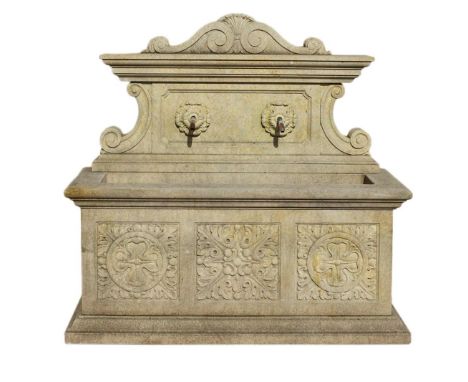 A Continental carved limestone wall fountain in early 17th century style  A Continental carved limestone wall fountain in ear