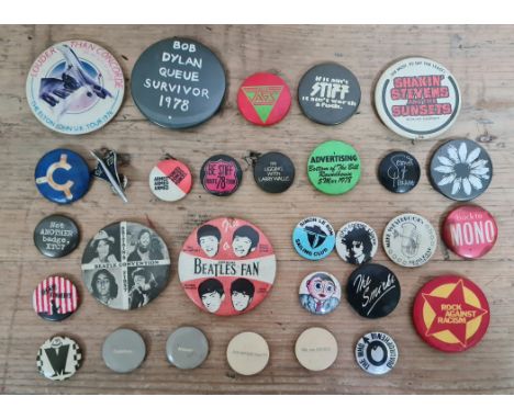A collection of vintage music related pin badges to include Stiff records, Elton John, Simon Le Bon, Frank Sidebottam, Beatle