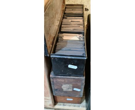 Three boxes of mainly Victorian glass magic lantern slides.