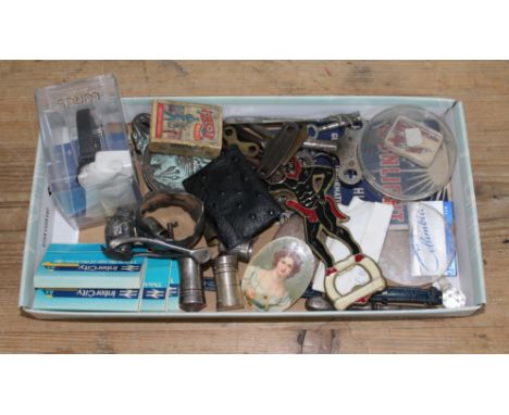 A tray of assorted bric a brac including an erotic devil bottle opener, clock keys etc. 