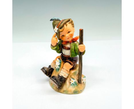 Mountaineer porcelain figurine from the 1997 M.I. Hummel Club Convention features a boy sitting on a rock and holding a walki