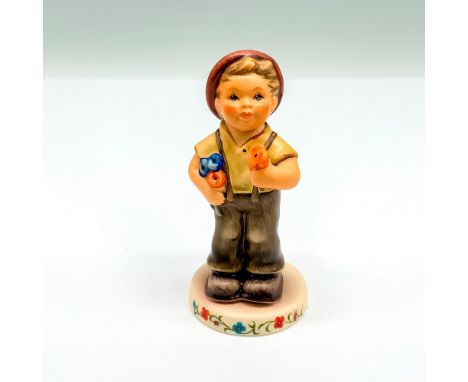 This special edition figurine depicts a young boy holding flowers. It has the Goebel backstamp on the bottom. Item comes with