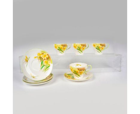 4 lovely white bone china teacups with matching saucers decorated with yellow daffodils and light green trim. Shelley backsta